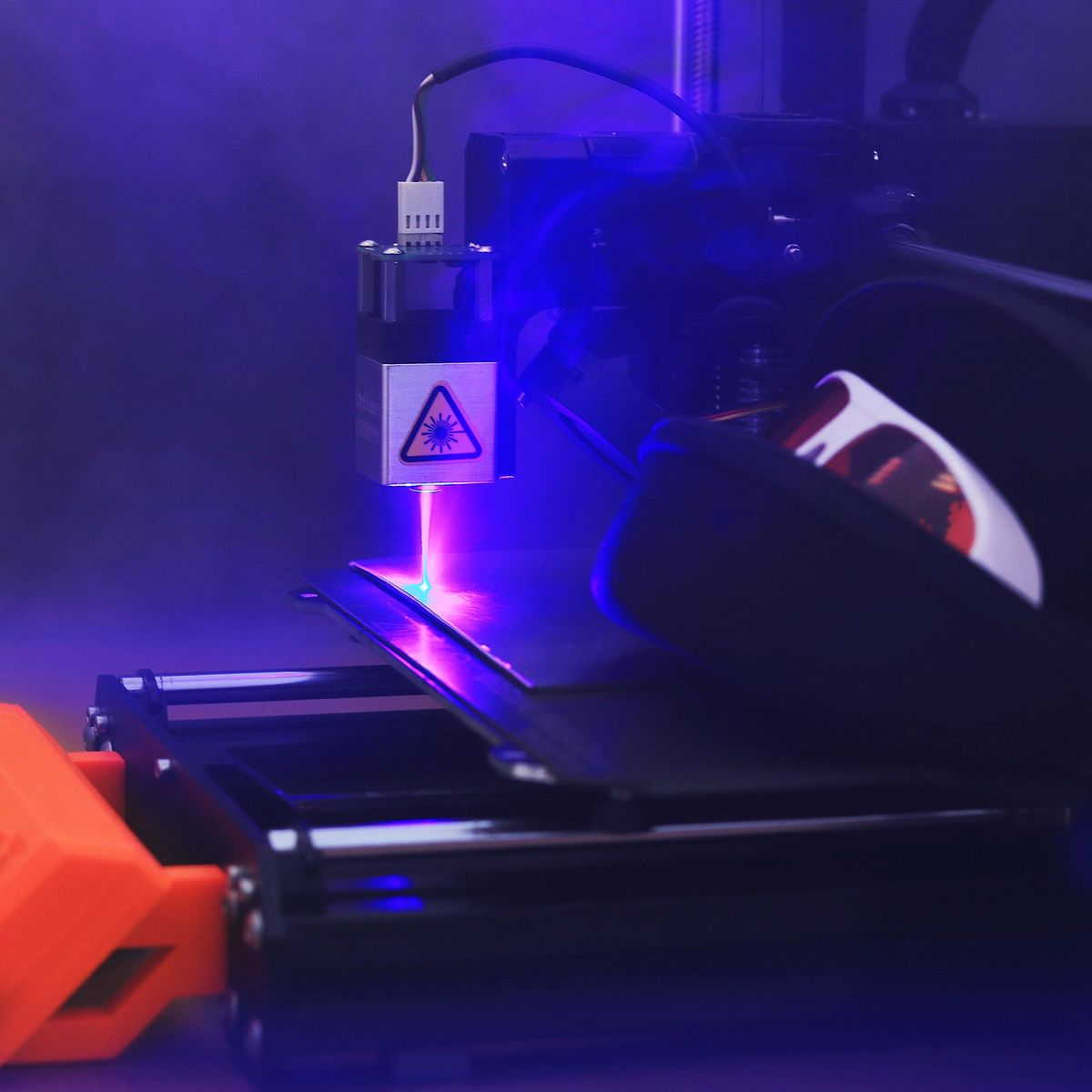 Machine de gravure laser CNC en action réalisant une découpe de précision dans un atelier industriel